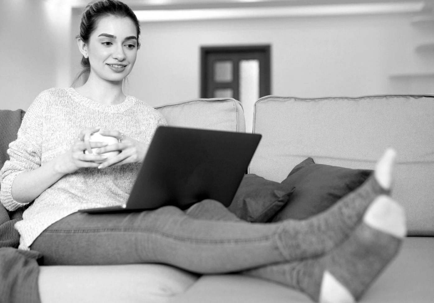 Pareja joven planificando presupuesto en casa con laptop y documentos financieros
